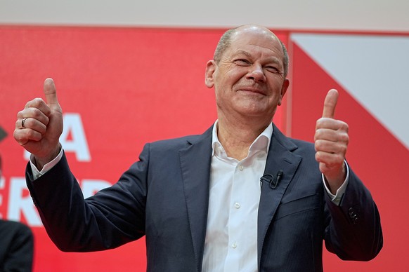 Olaf Scholz, SPD chancellor-designate and executive federal minister of finance, raises his thumbs after the SPD party convention at Willy Brandt House approved the planned coalition agreement in Berl ...