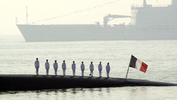 FILE - In this Feb.17, 2001 file photo, French naval officers on board the French nuclear submarine Perle stand at attention during India's first International Fleet Review, off Bombay's coa ...