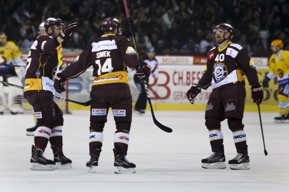 Geneve-Servette&#039;s forward Juraj Simek #14 celebrates his goal with teammates defender Goran Bezina, left, and forward Daniel Rubin, right, after scoring the 2:2, during the second leg of the play ...