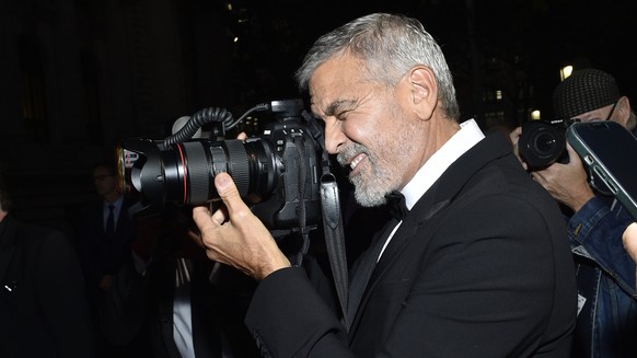 George Clooney takes a photograph at the Clooney Foundation for Justice Albie Awards at The New York Public Library on Thursday, Sept. 29, 2022, in New York. (Photo by Evan Agostini/Invision/AP)
Georg ...