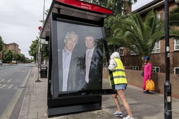 Activists put up a poster showing President Donald Trump and Jeffrey Epstein near the U.S. Embassy in London, Thursday, July 17, 2025.(AP Photo/Thomas Krych)
Britain Trump Epstein