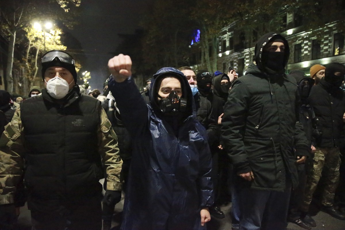 Demonstrators stand in front of the police during a rally to protest against the government's decision to suspend negotiations on joining the European Union in Tbilisi, Georgia, early Wednesday,  ...