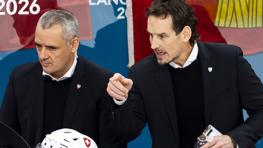 Patrick Fischer, right, head coach of Switzerland national ice hockey team, gestures next to Jan Cadieux, left, assistant coach of Switzerland national ice hockey team, during the men's group A p ...