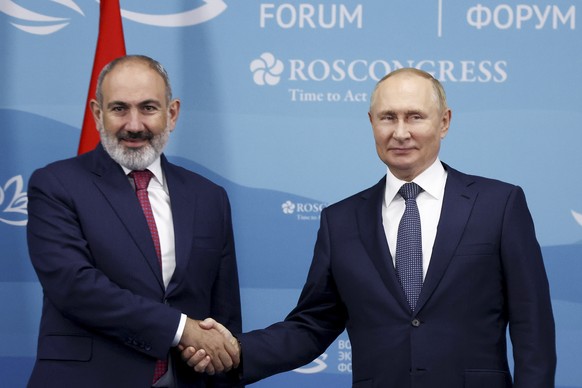 Russian President Vladimir Putin, right, and Armenian Prime Minister Nikol Pashinyan pose for a photo during their meeting on the sideline of the Eastern Economic Forum in Vladivostok, Russia, Wednesd ...