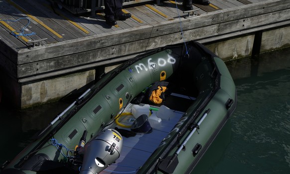 A dingy is moved from a British Border Force patrol boat after people believed to be migrants were pickup from the dingy in the English Channel in Dover harbour, England, Thursday, Sept. 16, 2021. (AP ...