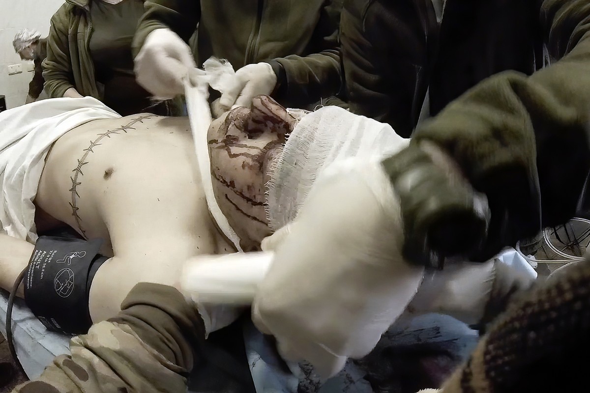 Yuliia Paievska, known as Taira, and other medical personnel bandage the head of an injured serviceman Mariupol, Ukraine, Feb. 24, 2022. Using a body camera, she recorded her team's frantic effor ...