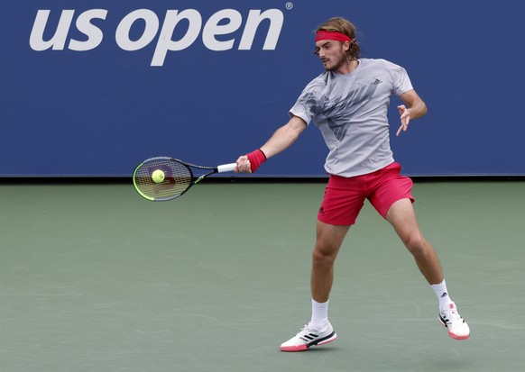 epa08637943 Stefanos Tsitsipas of Greece hits a return to Albert Ramos-Vinolas of Spain a during their match on the first day of the US Open Tennis Championships the USTA National Tennis Center in Flu ...
