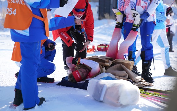 epa09761189 Irene Cadurish of Switzerland receives medical attention during the Women&#039;s Biathlon 4x6km Relay race at the Zhangjiakou National Biathlon Centre at the Beijing 2022 Olympic Games, Zh ...