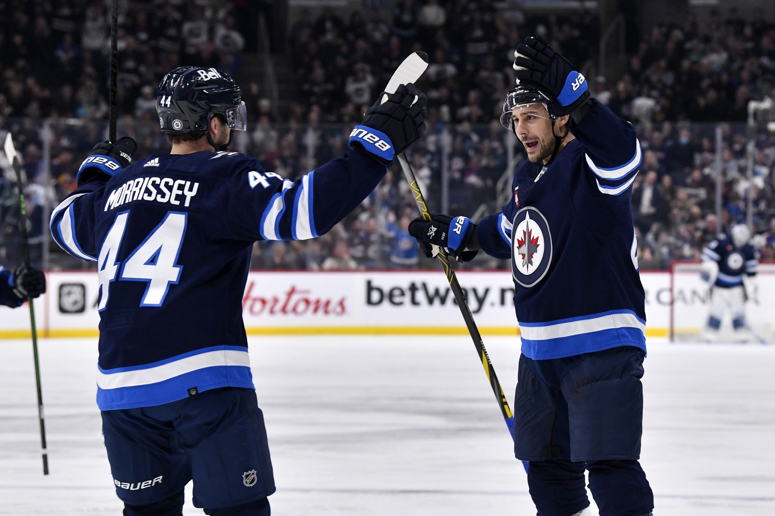 Winnipeg Jets&#039; Nino Niederreiter celebrates his goal against the San Jose Sharks with teammate Josh Morrissey during the second period of an NHL hockey game, in Winnipeg, Manitoba, on Monday Marc ...