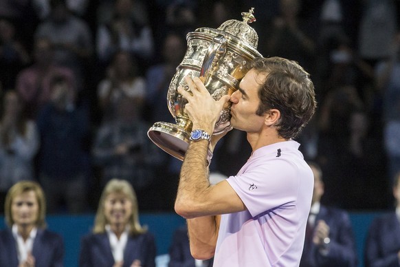 Switzerland&#039;s Roger Federer kisses the trophy during the award ceremony after the final between Switzerland&#039;s Roger Federer and Argentina&#039;s Juan Martin del Potro at the Swiss Indoors te ...