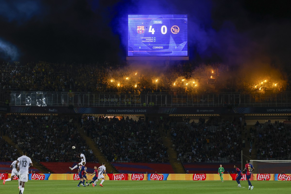 Supporters fire flares during the Champions League soccer match between Barcelona and Young Boys at the Lluis Companys Olympic Stadium in Barcelona, Spain, Tuesday, Oct. 1, 2024. (AP Photo/Joan Monfor ...