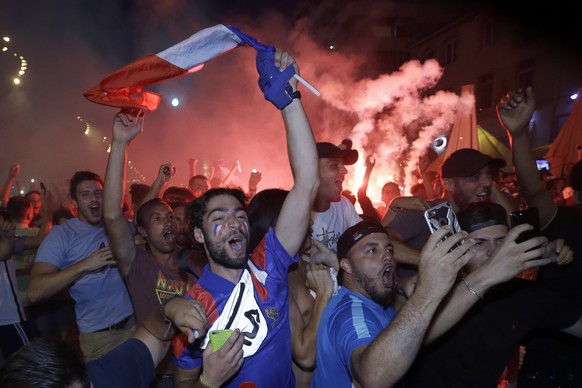 French soccer fans celebrate on the final whistle after watching a live broadcast of the semifinal match between France and Belgium at the 2018 soccer World Cup, in Marseille, southern France,Tuesday  ...