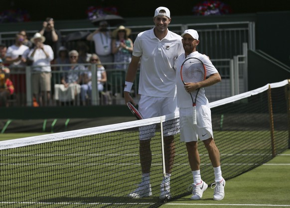 John Isner of the United States, left, and Israel&#039;s Dudi Sela pose for the media before their Men&#039;s Singles Match on day four at the Wimbledon Tennis Championships in London, Thursday, July  ...