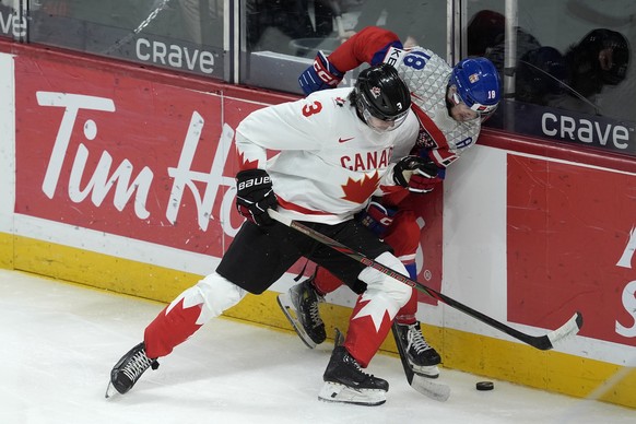 Canada defenseman Sam Dickinson (3) checks Czech Republic forward Matej Mastalirsky (18) during the second period of a quarterfinal match at the world junior hockey championship in Ottawa, Ontario, Th ...