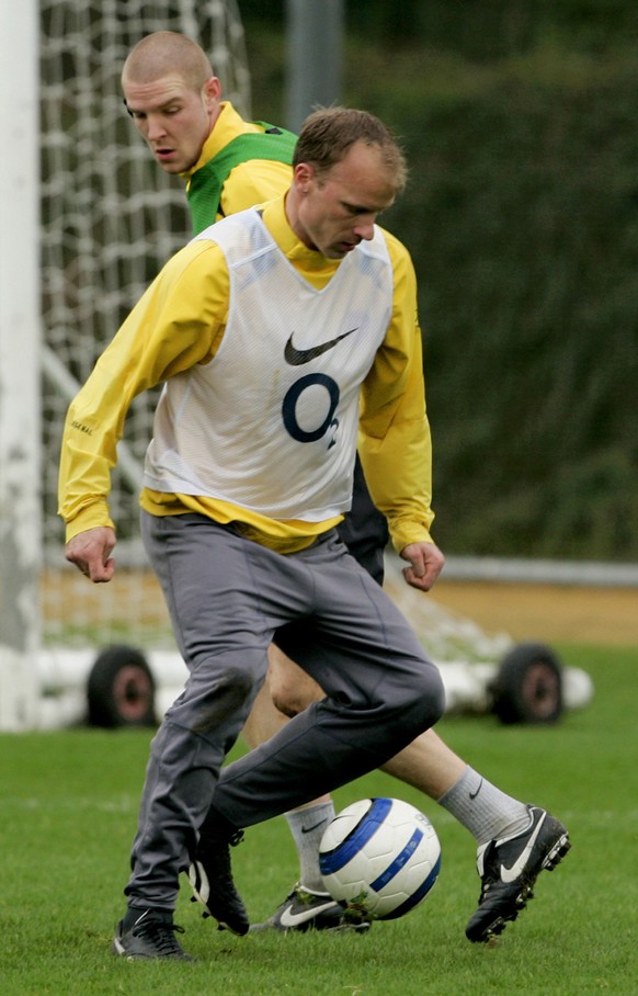 Arsenal&#039;s Dutch striker Dennis Bergkamp, right, challenges for the ball with his Swiss teammate Philippe Senderos during a training session, at the club&#039;s training facilities in north London ...