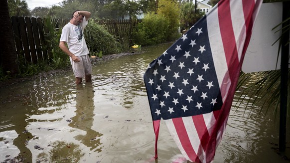 Tybee Island resident Joe Murphy wipes the sweat off his face while standing in knee deep water from Tropical Storm Irma outside his house, Monday, Sept., 11, 2017, on Tybee Island, Ga. (AP Photo/Step ...
