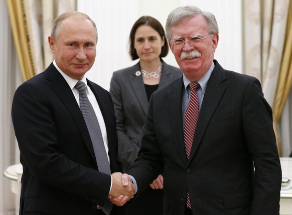 Russian President Vladimir Putin, left, shakes hands with U.S. National security adviser John Bolton during their meeting in the Kremlin in Moscow, Russia, Tuesday, Oct. 23, 2018. (AP Photo/Alexander  ...