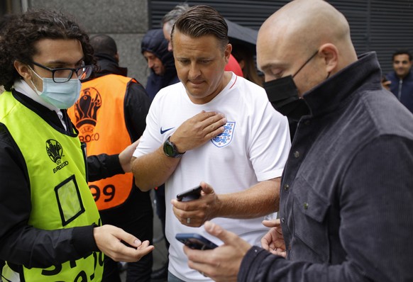 Stewards check for electronic tickets of fans as they enter Wembley Stadium in London, Sunday, July 11, 2021, prior to the Euro 2020 soccer championship final match between England and Italy. (AP Phot ...