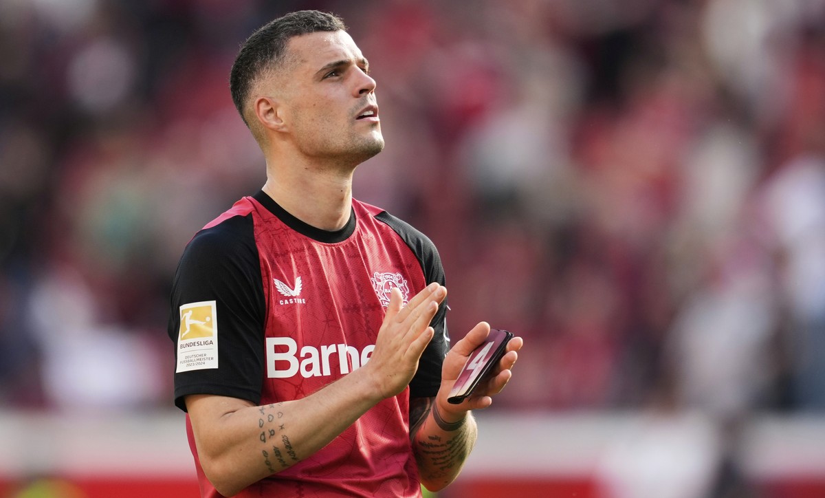 Leverkusen's Granit Xhaka applauds supporters at the end of the German Bundesliga soccer match between Bayer Leverkusen and FC Augsburg at the BayArena in Leverkusen, Germany, Saturday, April 26, ...
