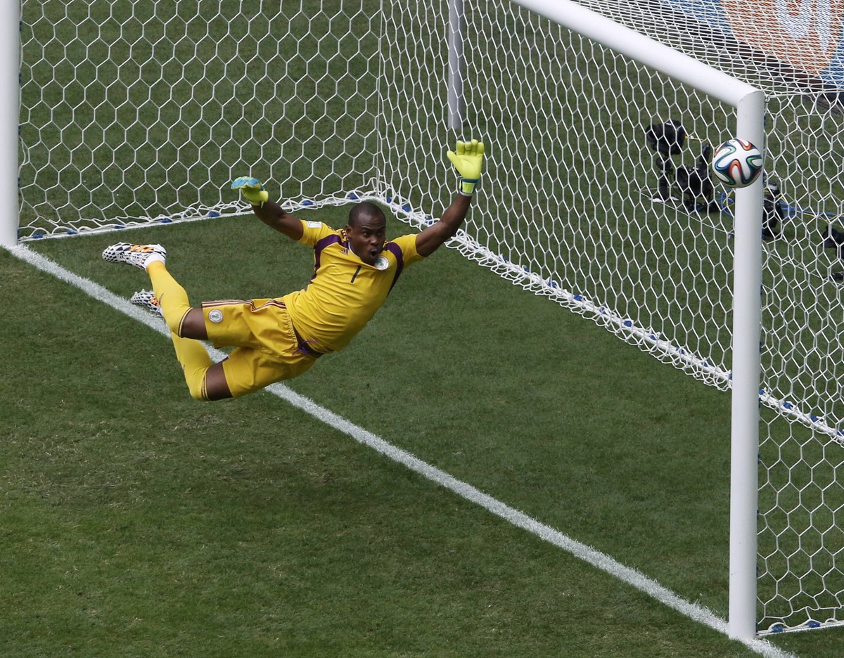 Nigeria's goalkeeper Vincent Enyeama jumps to make a save on a shot at goal by France's Paul Pogba (unseen) during their 2014 World Cup round of 16 game at the Brasilia national stadium in B ...
