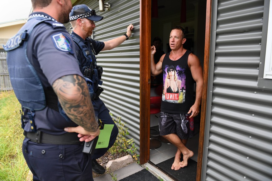 epa05871241 Police and SES advise a resident to evacuate a low lying area during preparations for Cyclone Debbie, in Ayr, south of Townsville, Queensland, 26 March 2017. The category 4 cyclone is expe ...