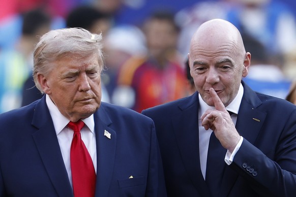 epaselect epa13121822 US president Donald Trump (L) and FIFA President Gianni Infantino (R) leave the field after the victory ceremony of the FIFA World Cup 2026 final match Spain against Argentina, i ...