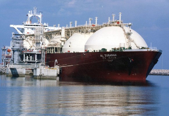 FILE - This undated file photo shows a Qatari liquefied natural gas (LNG) tanker being loaded with LNG, consisting primarily of methane, at Raslaffans Sea Port, northern Qatar.  The state oil and...