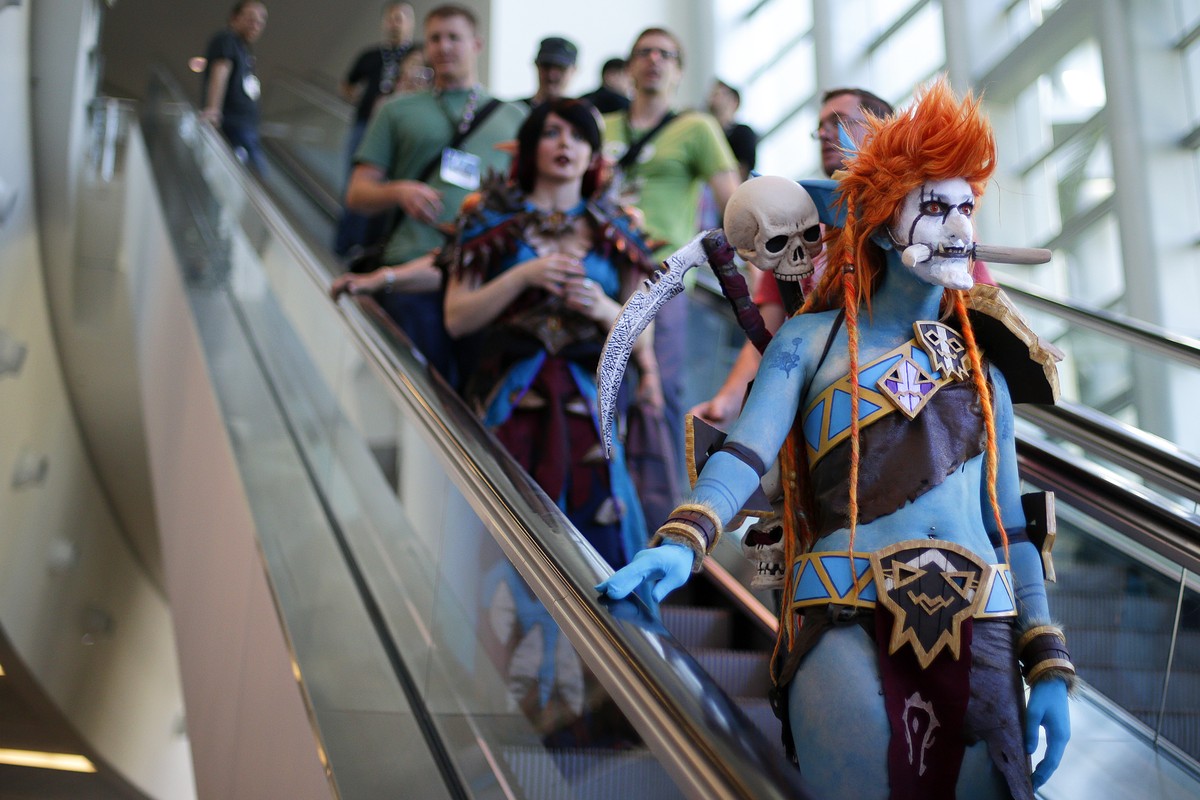 A woman dressed as Voljin from the video game World of Warcraft rides an escalator at the BlizzCon, Friday, Nov. 6, 2015, in Anaheim, Calif. "World of Warcraft" maker Blizzard is hosting its ...