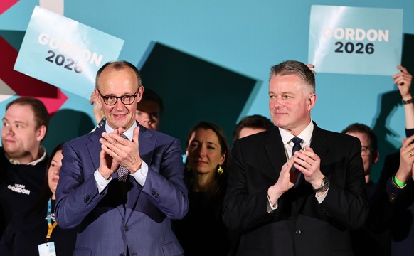 epa12836992 Christian Democratic Union (CDU) top regional candidate for the 2026 state elections in Rhineland-Palatinate Gordon Schnieder (R) and German Chancellor Friedrich Merz clap during a campaig ...