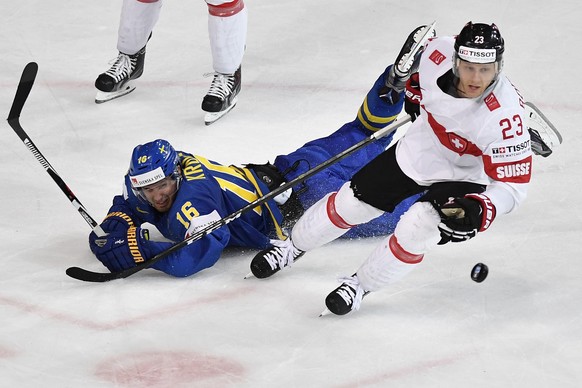 Switzerlandâs Simon Bodenmann, right, in action against Swedenâs Marcus Krueger during their Ice Hockey World Championship quarter final match between Switzerland and Sweden in Paris, France on Th ...