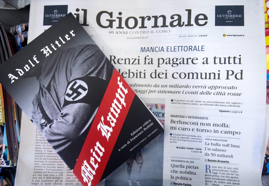 epa05359021 A copy of &#039;Mein Kampf&#039; written by Adolf Hitler on sale with Italian newspaper Il Giornale, in Rome, Italy, 12 Jun 2016. Italian Prime Minister Matteo Renzi has condemned the deci ...