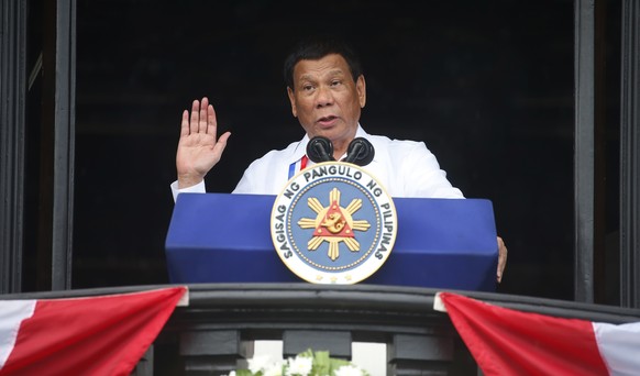 Philippine President Rodrigo Duterte gestures while addressing the crowd after leading the flag-raising rites at the 120th Philippine Independence Day celebration at the Emilio Aguinaldo Shrine at Kaw ...