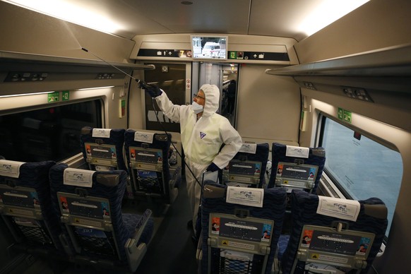 epa08156909 A sanitation worker sprays disinfectant for precaution against coronavirus on the train at Suseo Station in Seoul, South Korea, 24 January 2020. Over 800 people have been affected by the W ...