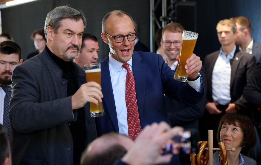 epa11835915 Chairman of Germany&#039;s Christian Democratic Union (CDU) Friedrich Merz (R) and State Premier of Bavaria and Christian Social Union (CSU) chairman Markus Soeder (L) attend a Bavarian ve ...