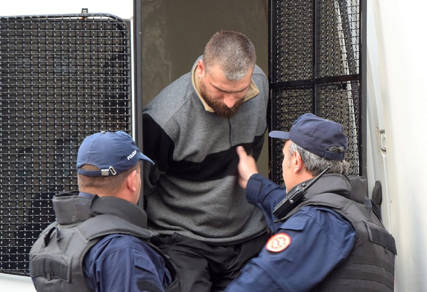 epa05588052 Montenegrin police escort men to a court session with the state attorney in Podgorica, Montenegro, 16 October 2016. Montenegrin police say they have arrested 20 Serbian people who are susp ...