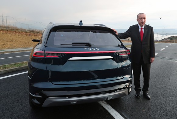 epa08091986 A handout photo made available by the Turkish Presidential Press Office shows Turkish President Recep Tayyip Erdogan posing next to the first domestically-designed Turkish prototype of the ...