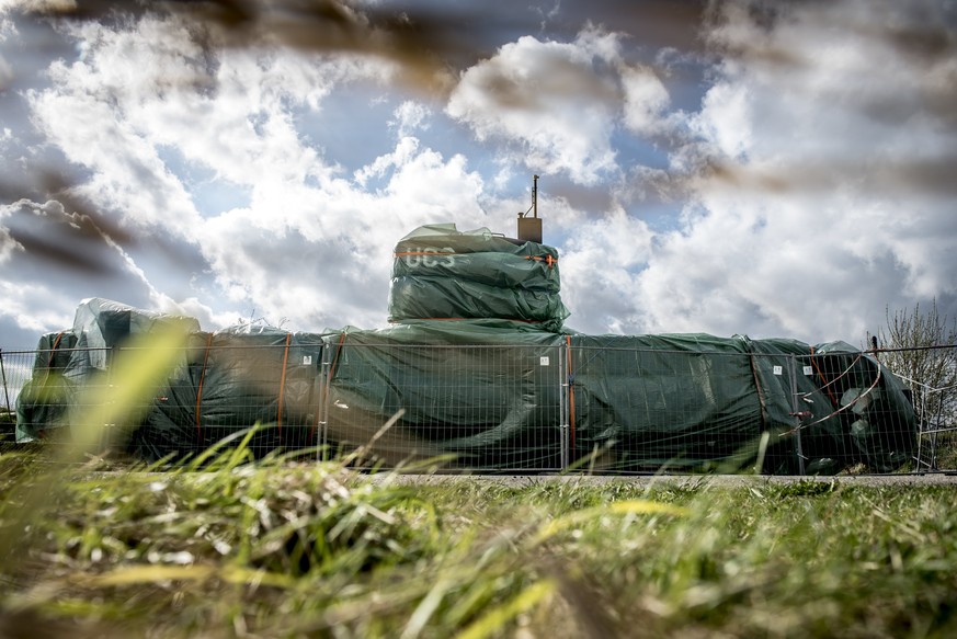 epaselect epa06692270 The submarine UC3 Nautilus is seen covered with green tarpaulin in Nordhavn in Copenhagen, Denmark, 25 April 2018. Danish inventor Peter Madsen has been sentenced to life in pris ...