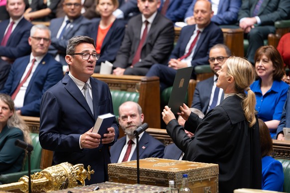 Andy Burnham, front left, is sworn-in as an MP in the House of Common in London, England, Germany, Monday, June 22, 2026. (House of Commons via AP)
Britain Politics