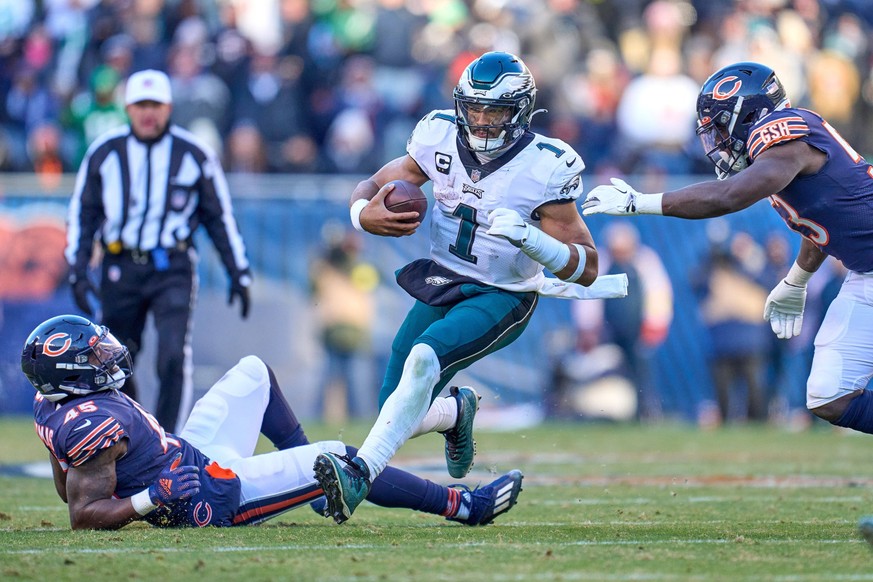 CHICAGO, IL - DECEMBER 18: Philadelphia Eagles quarterback Jalen Hurts 1 runs with the football in action during a game between the Philadelphia Eagles and the Chicago Bears on December 18, 2022, at S ...