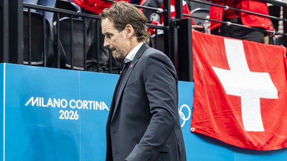 Patrick Fischer, head coach of Switzerland national ice hockey team, looks disappointed as they leave his bench after the second period, during the men's group A preliminary round game between Ca ...