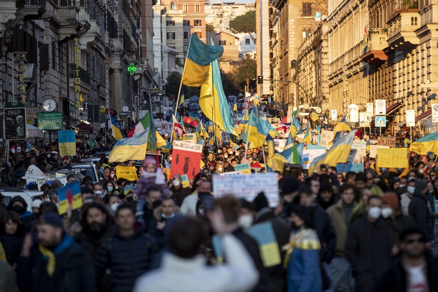 epa09789668 People hold Ukrainian flags as they demonstrate against the war in Ukraine, in Rome, Italy, 27 February 2022. Russian troops entered Ukraine on 24 February prompting the country&#039;s pre ...