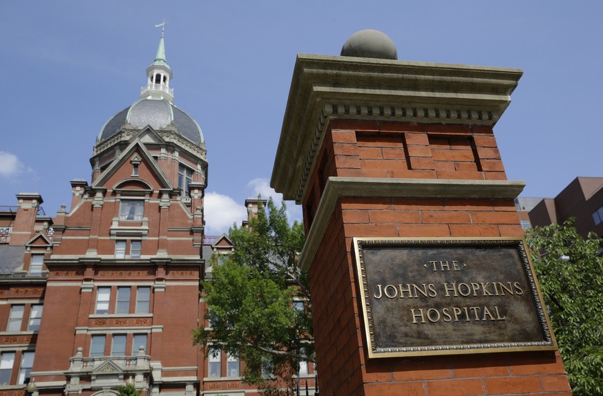 A sign stands in front of part of the Johns Hopkins Hospital complex, July 8, 2014, in Baltimore. Most medical students at Johns Hopkins University will no longer pay tuition thanks to a $1 billion gi ...