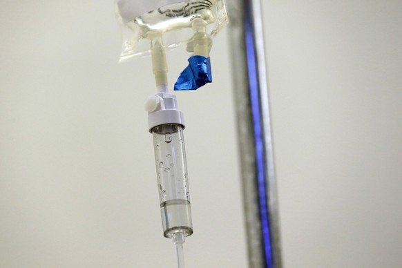FILE - In this May 25, 2017 file photo, chemotherapy drugs are administered to a patient at a hospital in Chapel Hill, N.C. Scaling back treatment in some cancers ? ovarian, esophageal and Hodgkin lym ...