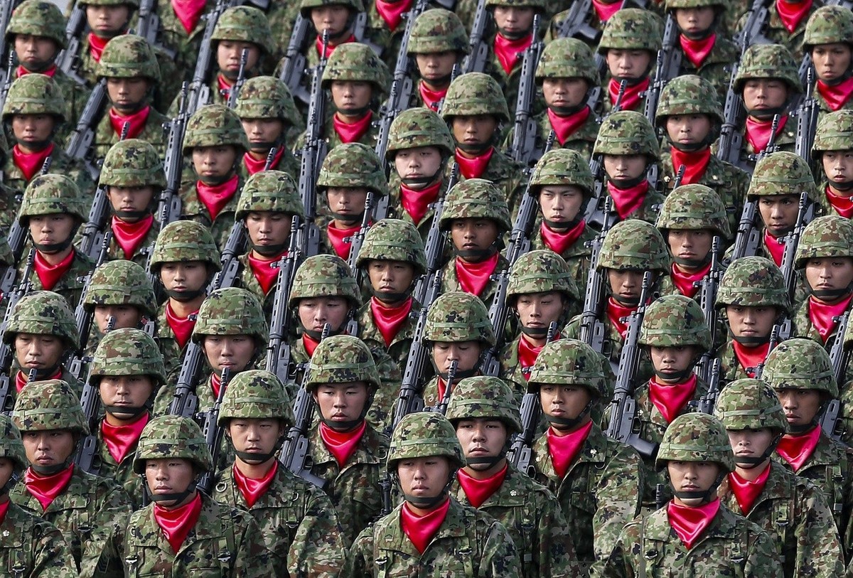 epa05599439 Japanese Ground Self Defense Force's military personnels march during a military parade at the Ground Self Defence Force's Asaka training ground in Asaka, Saitama Prefecture, nor ...