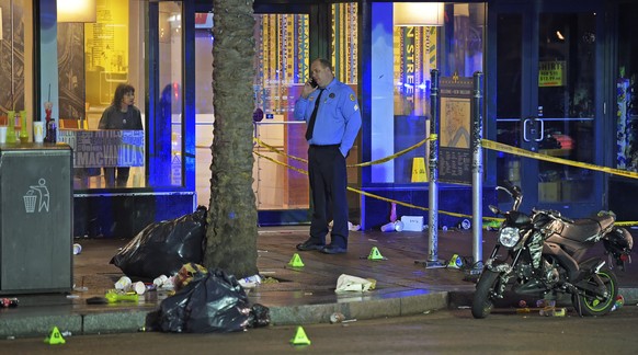 A woman looks out from inside a McDonald's fast food restaurant as New Orleans police investigate the scene of a shooting Sunday, Dec. 1, 2019, on the edge of the city's famed French Quarter ...