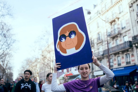 Gisele Pelicot Publishes Memoirs After Mass Rape Trial File photo - A protester holds a placard / signs with a portrait of Gisele Pelicot during a demonstration march as part of the 2025 international ...