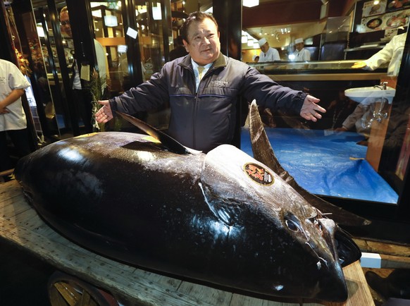 epa07262573 Kiyoshi Kimura, President of Japanese sushi chain Sushi-Zanmai, shows off his bidding of a 275kg bluefin tuna in New Year 2019 first auction of Toyosu Market in Tokyo, Japan, 05 January 20 ...