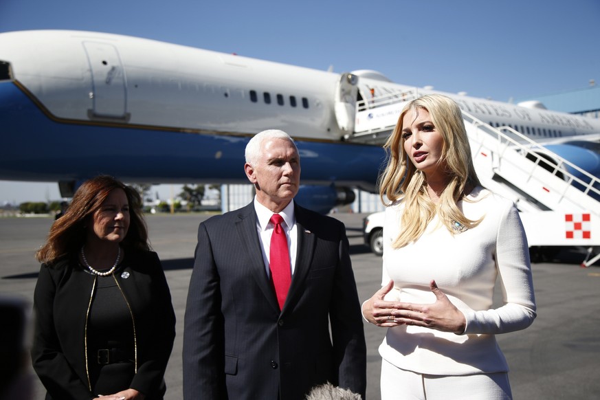 Backdropped by Air Force Two, Ivanka Trump, the daughter and assistant to President Donald Trump, speaks to the press standing next to Vice President Mike Pence, and his wife Karen, on an airport tarm ...