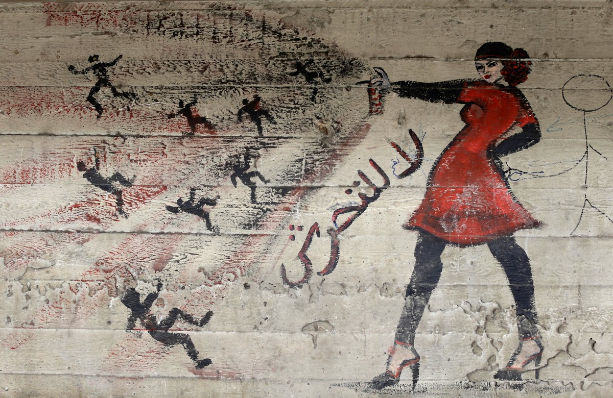 FILE - In this May 24, 2013 file photo, a mural with Arabic that reads "no harassment," is seen on a wall in Cairo, Egypt. The state National Council for Women, the highest women's righ ...