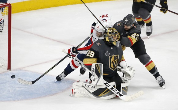 Washington Capitals center Lars Eller (20) scores on Vegas Golden Knights goaltender Marc-Andre Fleury, front, while under pressure from defenseman Luca Sbisa during the third period in Game 5 of the  ...